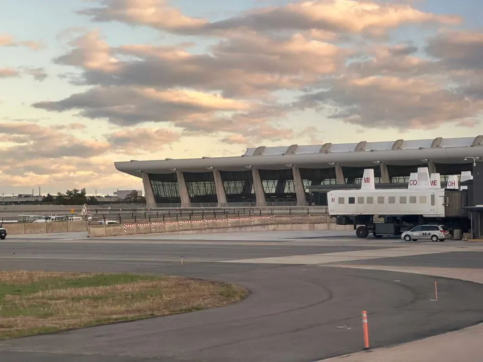 Mobile lounges at Dulles International Airport with the main terminal building in the background (staff photo by Angela Woolsey)