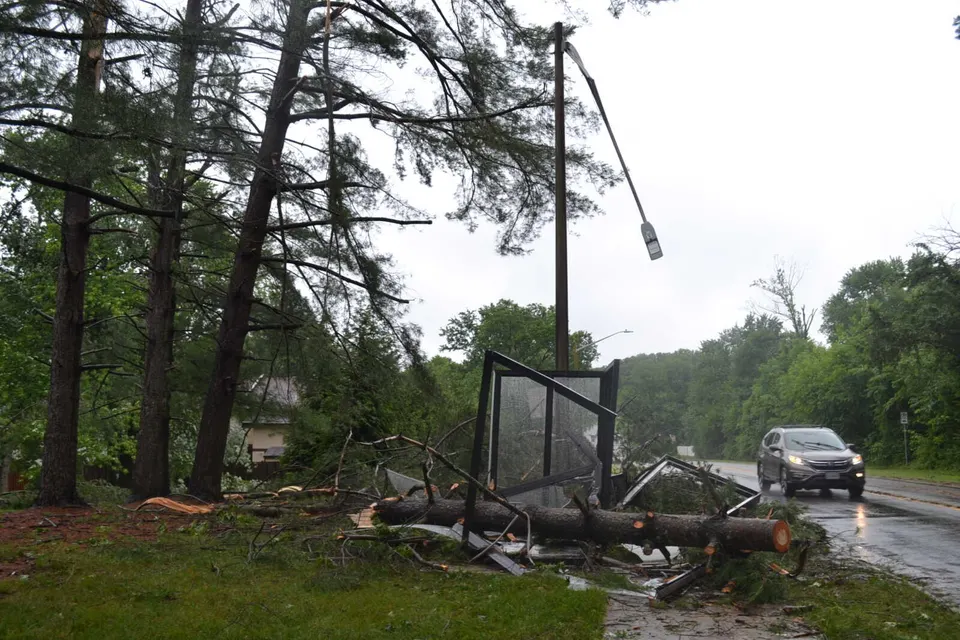 A broken streetlight and smashed bus shelter near Burke Road and Peppercorn Drive after a June 22, 2026 thunderstorm (staff photo by Mary Stachyra Lopez)