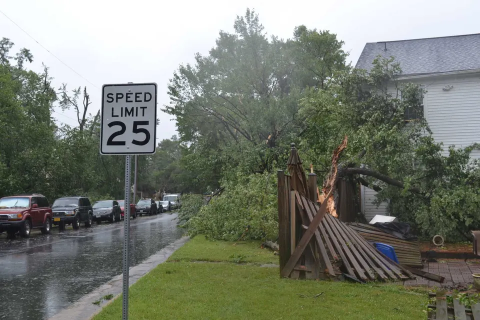 A fence knocked down by a tree in Burke after a storm on June 22, 2026 (staff photo by Mary Stachyra Lopez)