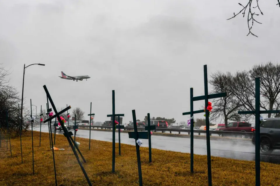 An American Airlines flight passes over nearly two dozen crosses near Gravelly Point, a tribute to the 67 victims of the mid-air collision over the Potomac River (staff photo...