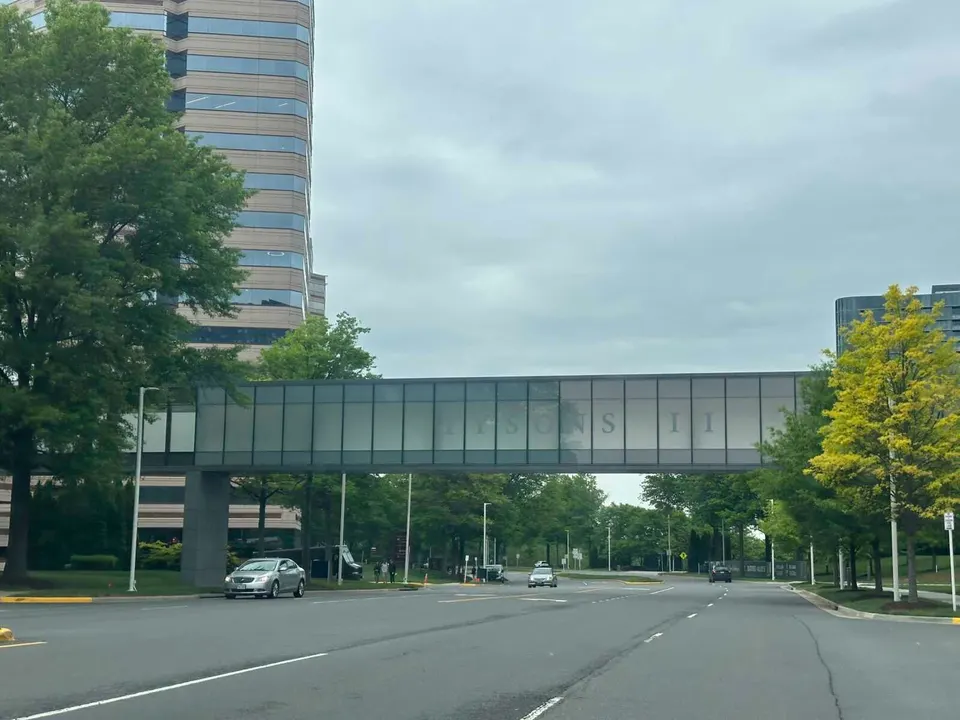 Tysons II pedestrian bridge over Tysons Blvd on a cloudy spring day (staff photo by Angela Woolsey)