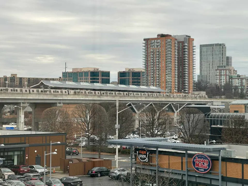 A train stops at the Spring Hill Metro station near Tysons West (staff photo by Angela Woolsey)