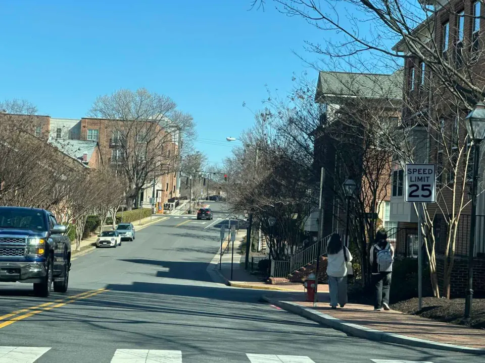 People walking down Whitehead Street in Fairfax City (staff photo by Angela Woolsey)