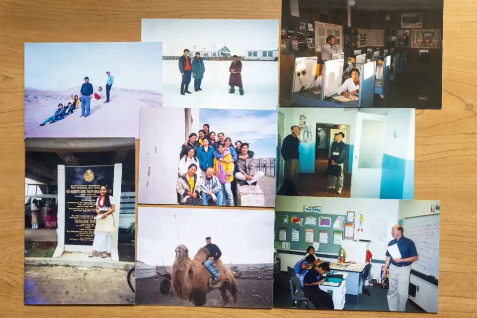 A collage of photos featuring a man around the world, on a camel, in classrooms, in a desert, etc.
