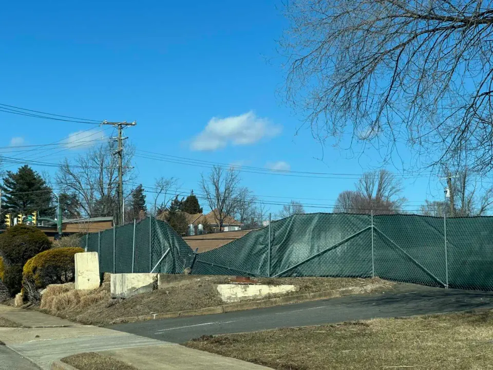 A portion of the fence around the future 444 Maple Avenue development site is sagging (staff photo by Angela Woolsey)
