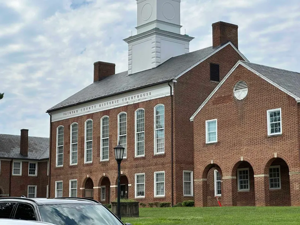 A vehicle passing the Fairfax County Historic Courthouse (staff photo by Angela Woolsey)
