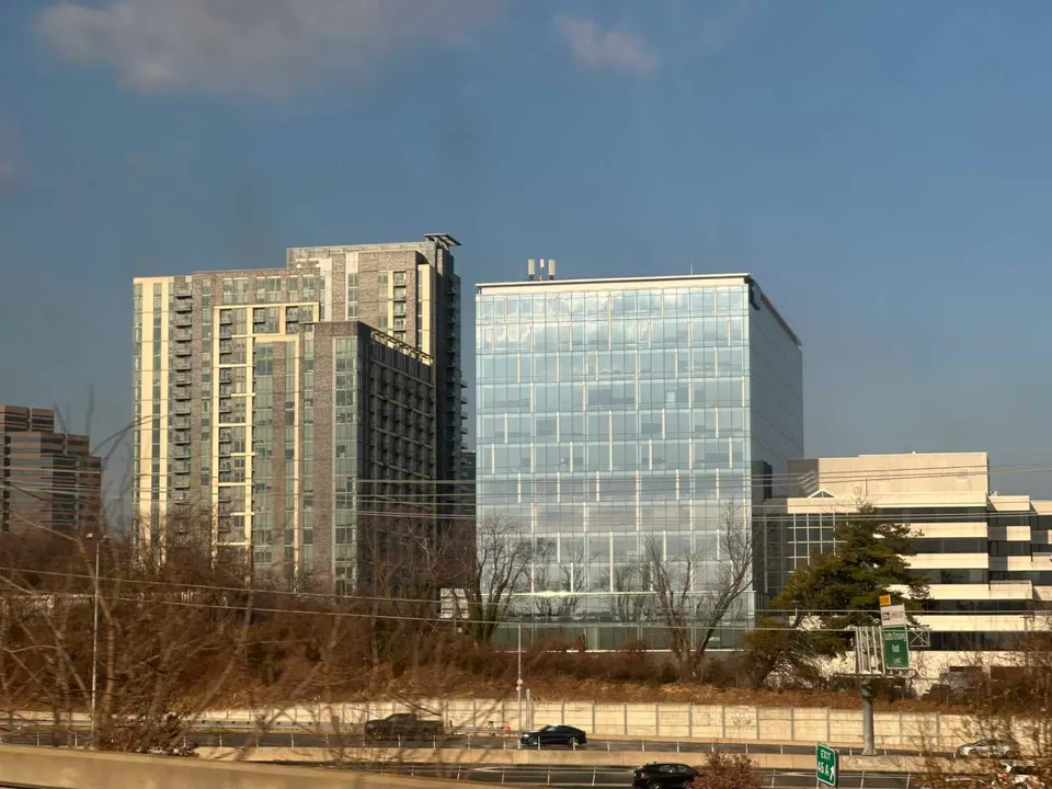 The Nouvelle apartment building and Silverline Center office building in Tysons with I-495 traffic below (staff photo by Angela Woolsey)