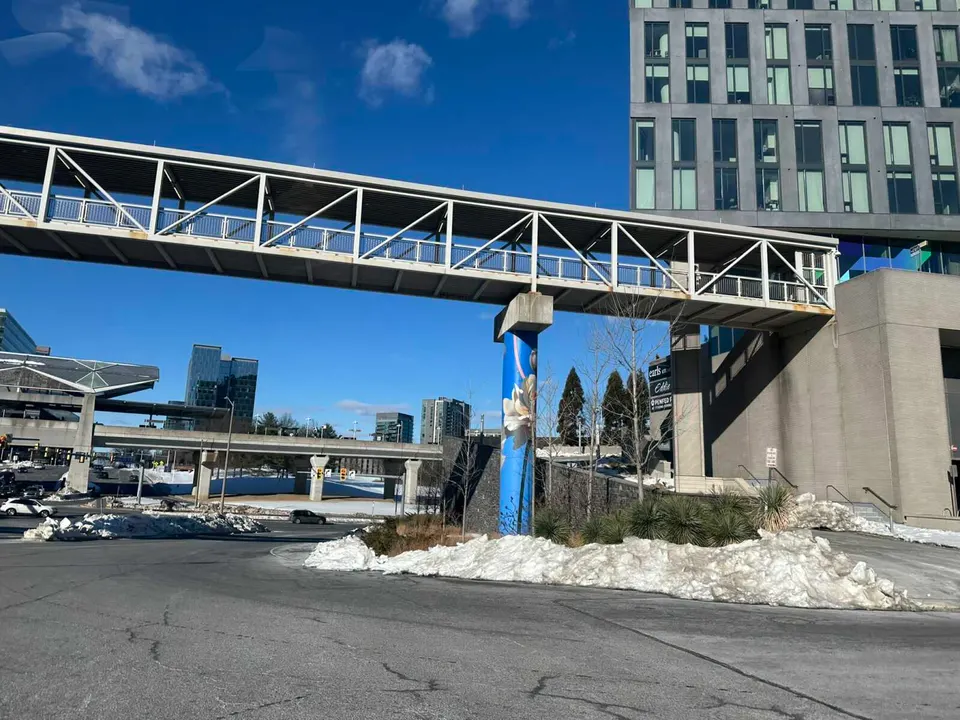 Snow pile around a pillar holding up the pedestrian walkway from Tysons Corner Center to the Tysons Metro station (staff photo by Angela Woolsey)