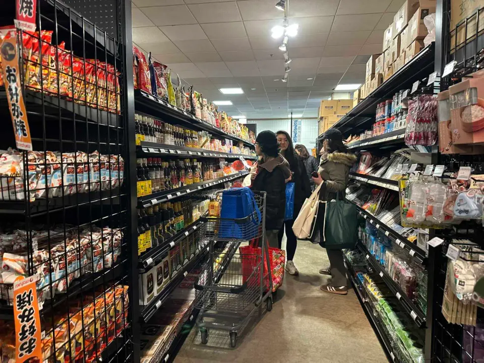 Shoppers browse sauces at Marufuji Japanese Market in Tysons (staff photo by Angela Woolsey)