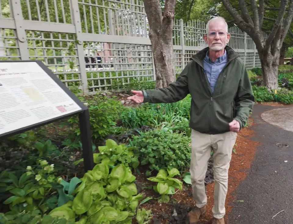 NOVA Parks historian Paul McCray stands in front of a plaque installed at Meadowlark Botanical Gardens in honor of Howard University students who protested Jim Crow in 1944...