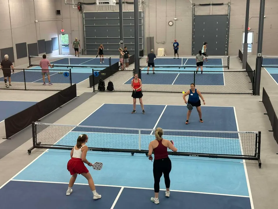 Players engage in a match at the Pickleball Club of Tysons (staff photo by Angela Woolsey)