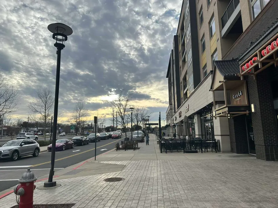 Late afternoon clouds over the Fairfax Blvd service drive outside Genki Izakaya in Scout on the Circle (staff photo by Angela Woolsey)