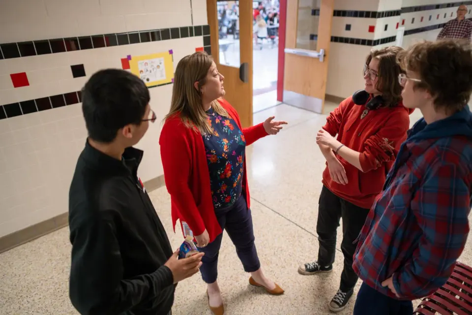 Alice Whitener talks to students in a hallway