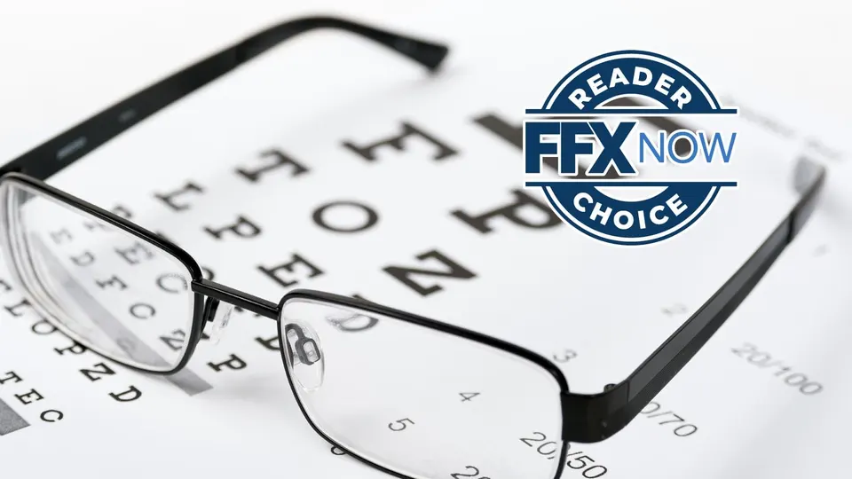 Glasses resting on an eye chart with a blue circular badge reading 'Reader Now Choice' in the foreground.