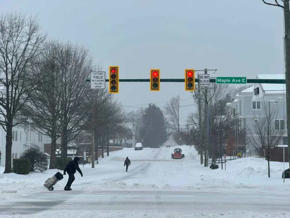 People walking at Maple Avenue and Park Street in Vienna during Winter Storm Fern on Jan. 25, 2026 (staff photo by Angela Woolsey)