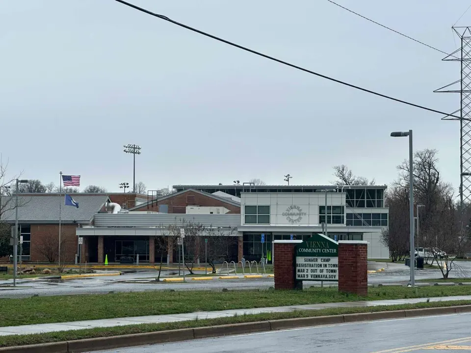 Flags outside the Vienna Community Center blow in the wind as rain falls (staff photo by Angela Woolsey)