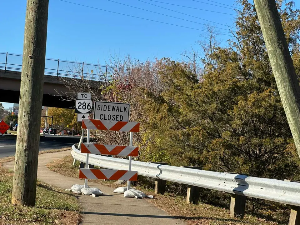 A construction barrier closes off a sidewalk on Sunset Hills Road near Fairfax County Parkway in Herndon (staff photo by Angela Woolsey)