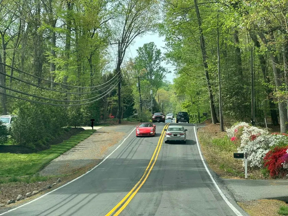 Cars drive on a hilly section of Prosperity Avenue in Woodburn (staff photo by Angela Woolsey)