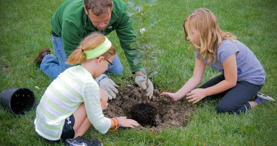 A family plants a tree from the Arbor Day Foundation (courtesy DPWES)