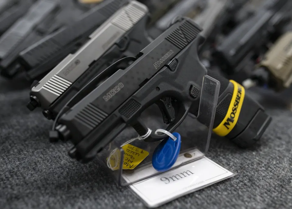 FILE – Pistols sit on display during the first day of the Silver Spur Gun and Blade Show, Jan. 22,…