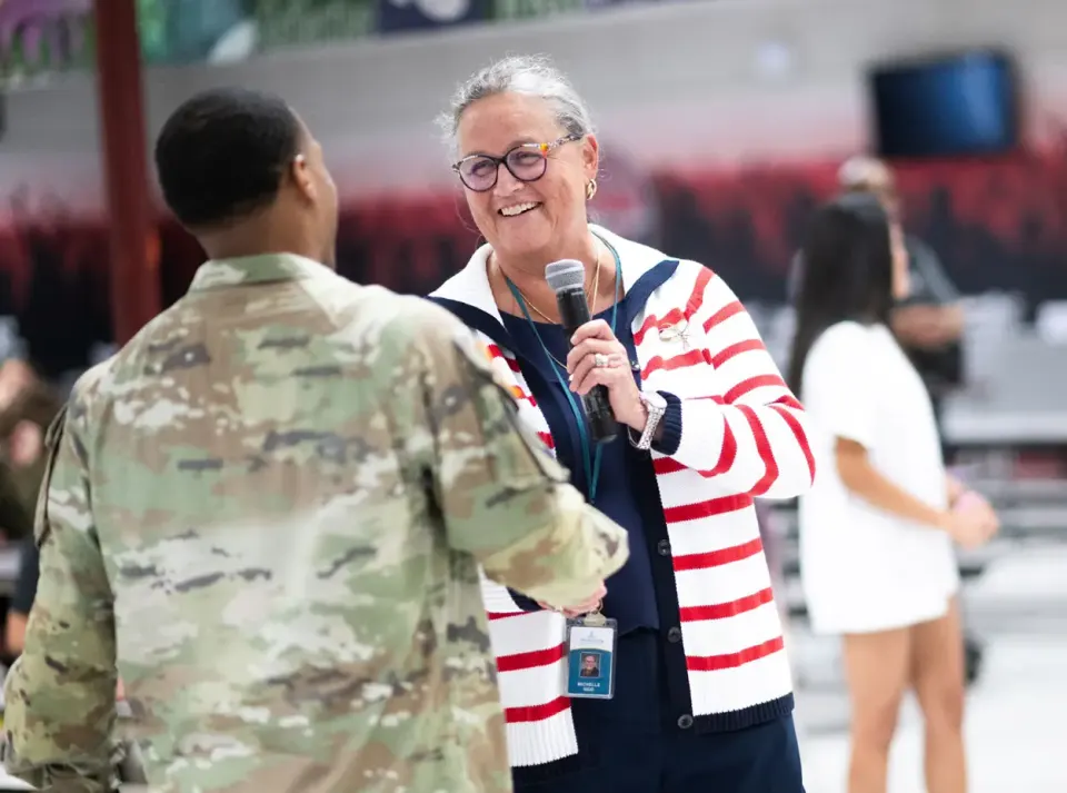 Dr. Reid speaking with a military member.
