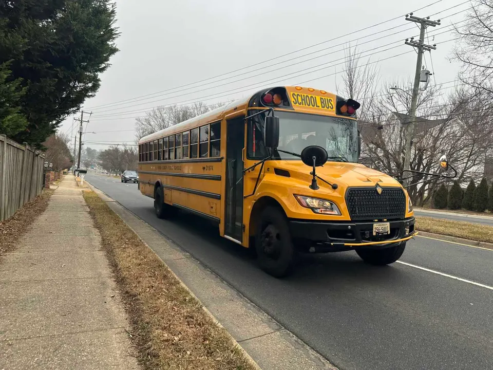 A Fairfax County school bus driving down Nutley Street in Vienna (staff photo by Angela Woolsey)