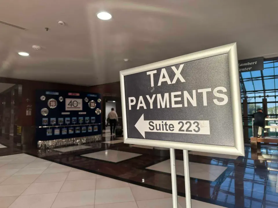 Sign points to the Department of Tax Administration in the Fairfax County Government Center (staff photo by Angela Woolsey)
