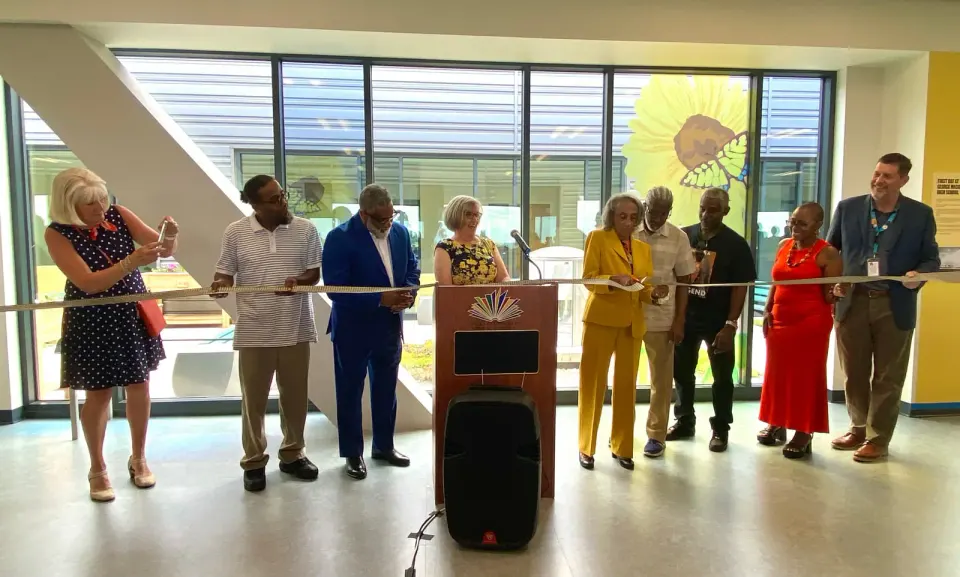 Marian Costner Selby (5th from left) cuts the ribbon opening Meridian High School's new Marian Costner Selby Peace Garden (behind the ribbon cutters, on the school's 5th floor...