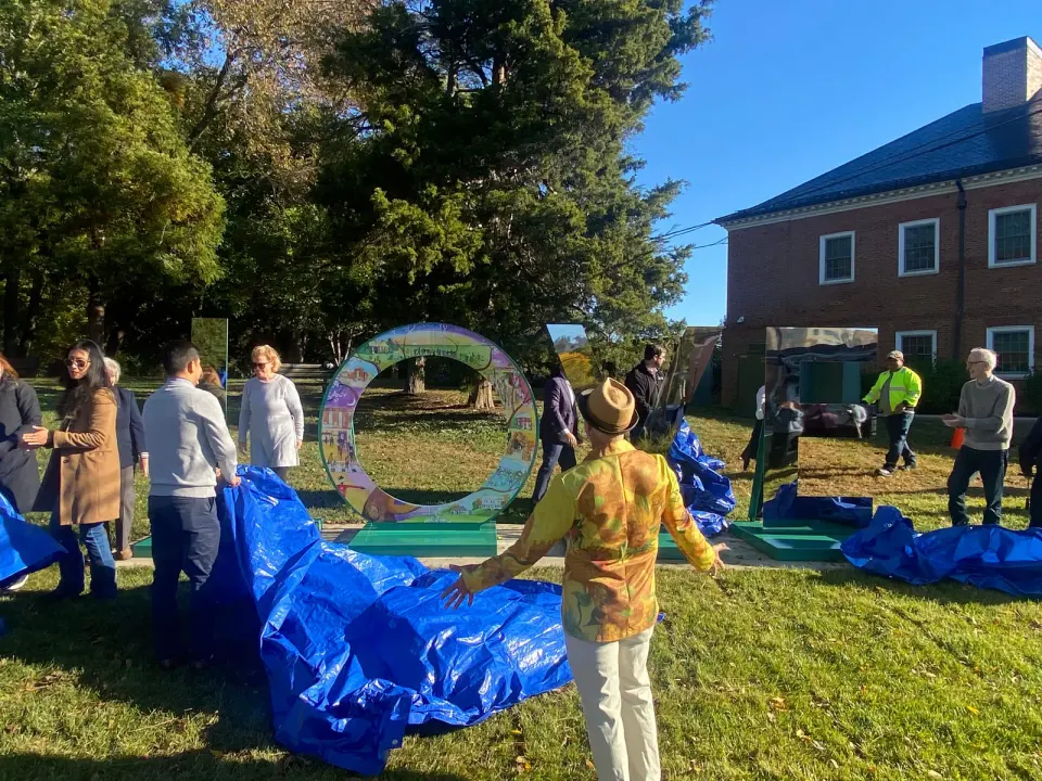 Painter of the "O," Bill Abel, (center with funky jacket, hat) reacts to unveiling of 'LOVE Letters' Sculpture next to City Hall, Oct. 22. Photo by Chris Jones.
