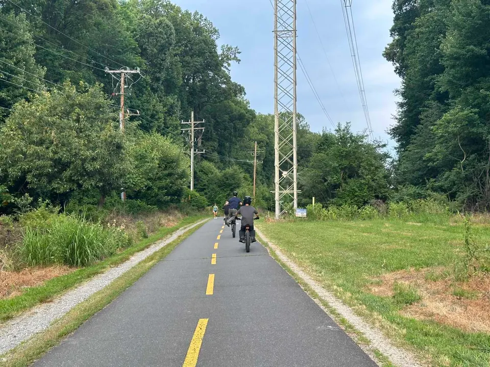 Kids ride electric dirt bikes on the W&OD Trail in Vienna (staff photo by Angela Woolsey)