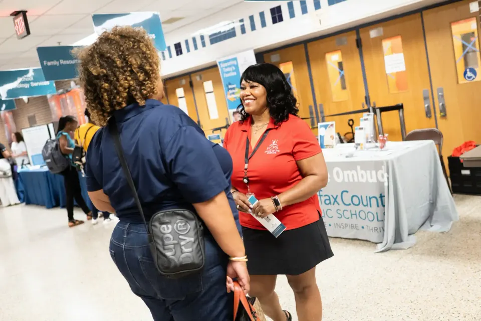 Two women talk at a networking event