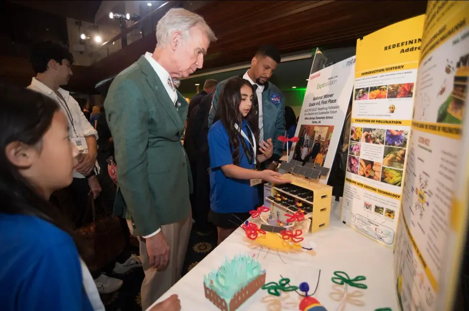 Bill Bye looking at a student's science project