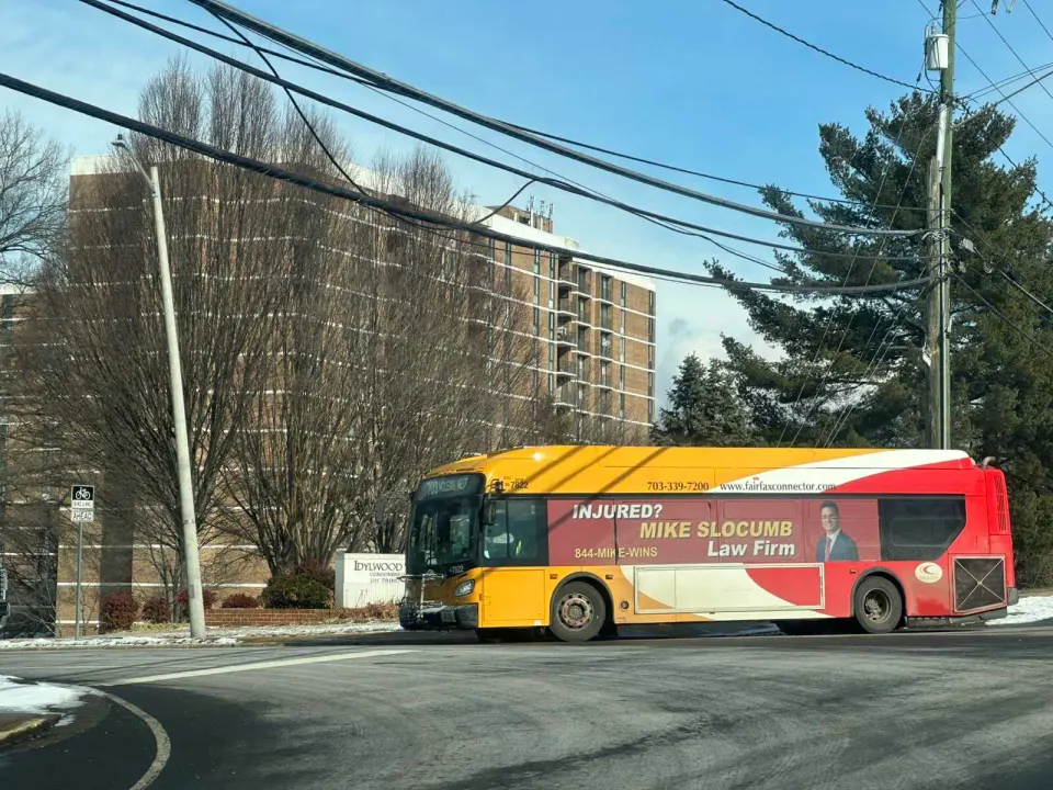 A Fairfax Connector bus passes the Idylwood Towers Condominiums (staff photo by Angela Woolsey)