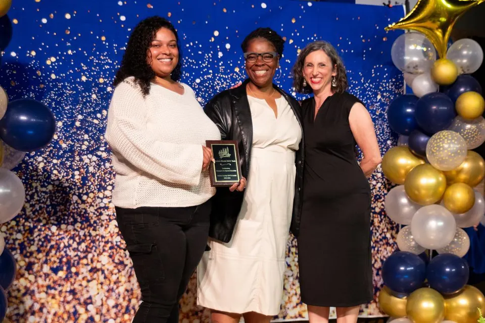 Award recipients pose with a plaque at a SEPTA recognition event.