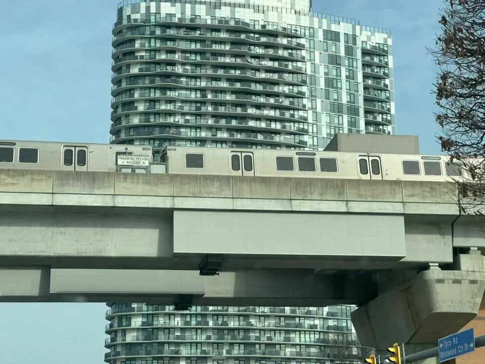 A Silver Line Metro train passes the Adaire Apartments in Tysons (staff photo by Angela Woolsey)