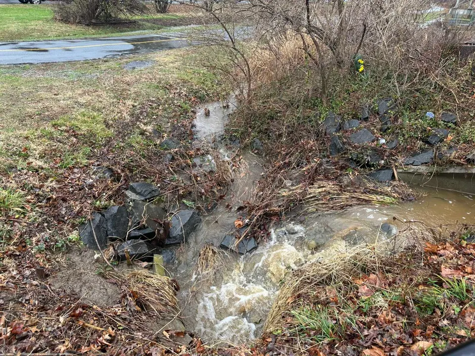 Stream runs into a culvert near the Washington & Old Dominion Trail in Vienna during rain storm (staff photo by Angela Woolsey)