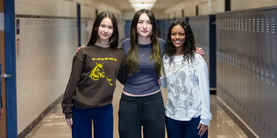three students smile for a photo