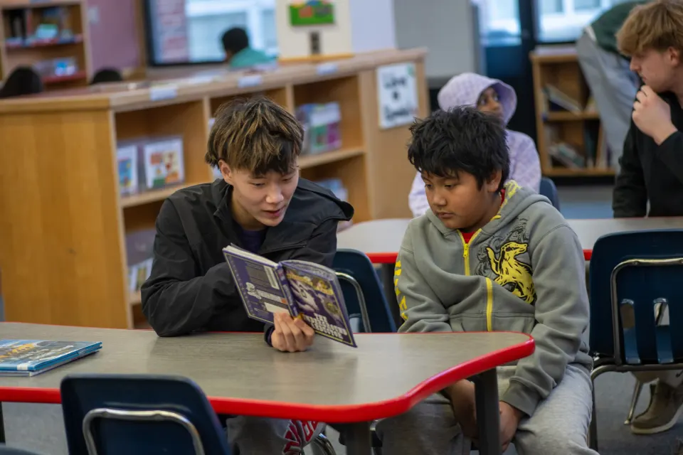 students reading a book together