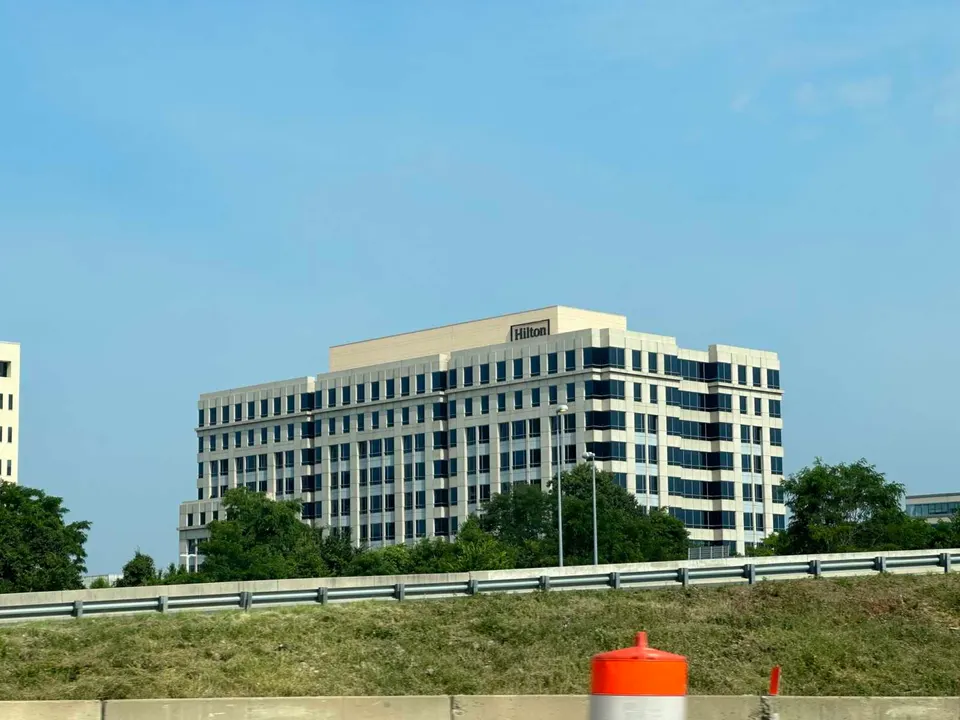 Hilton’s headquarters building in Tysons seen from I-495 (staff photo by Angela Woolsey)
