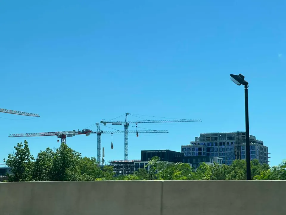 Construction cranes working on the West Falls development in Falls Church (staff photo by Angela Woolsey)