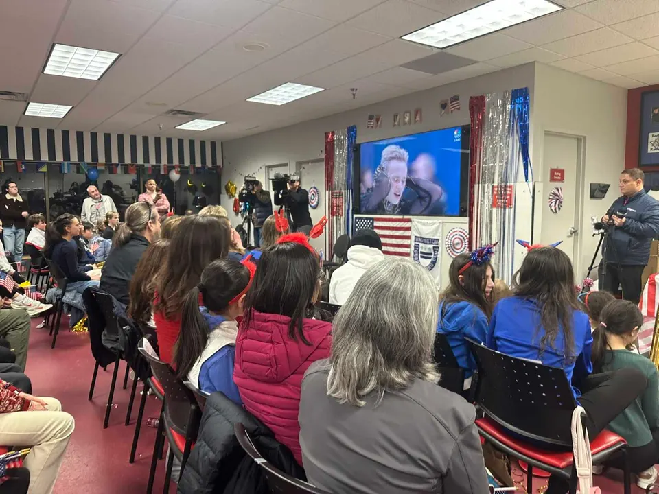 People at SkateQuest in Reston watch Ilia Malinin after his free skate at the Milan Cortina Olympics (staff photo by Angela Woolsey)