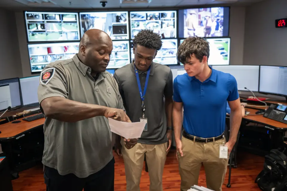 FCPS interns speak with a safety and security staff member