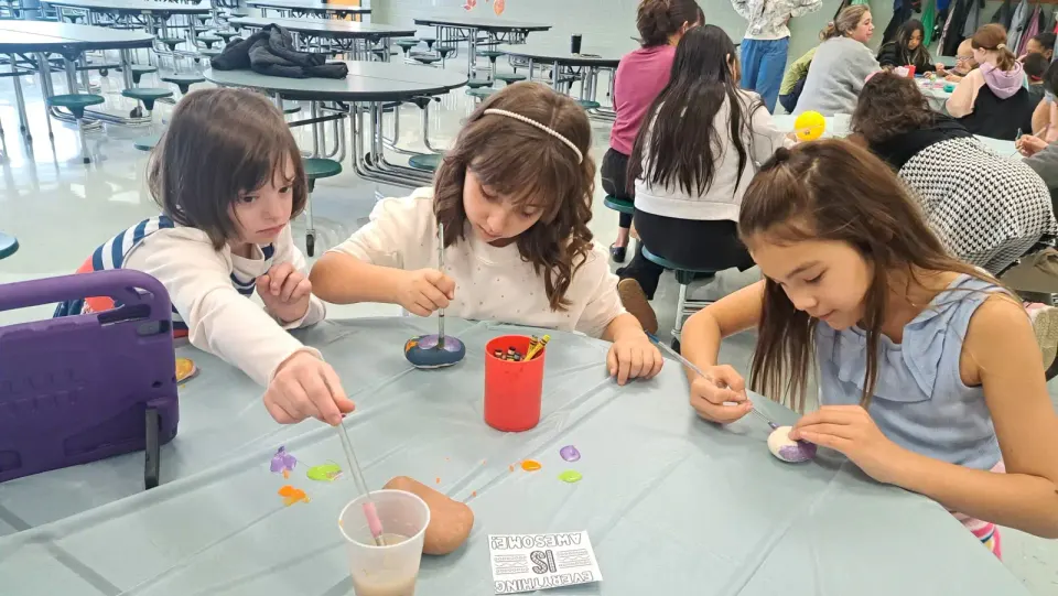 Fairfax Villa students in the Peer Buddies program paint "Kindness Rocks" together.
