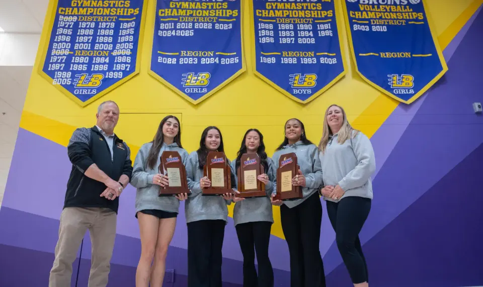 gymnasts smile with their coaches
