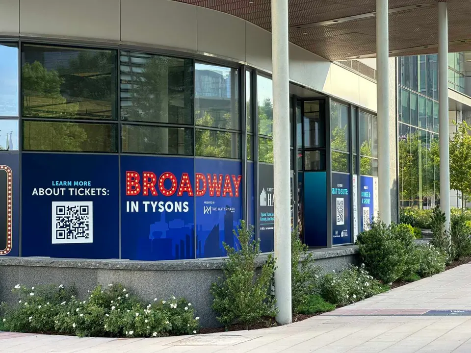 La Omri will occupy a vacant space at Capital One Center currently covered by a “Broadway in Tysons” wrap (staff photo by Angela Woolsey)