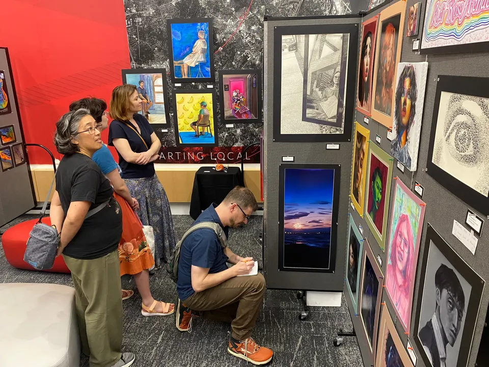 Studious observers explore the works of senior HL IB Art student Adi Rose Henderson, on right. Photo by Chris Jones.