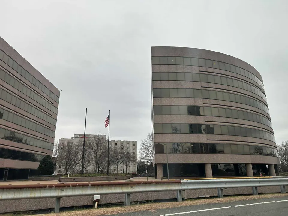 A U.S. flag in the wind at the American Center East office building on Boone Blvd in Tysons (staff photo by Angela Woolsey)