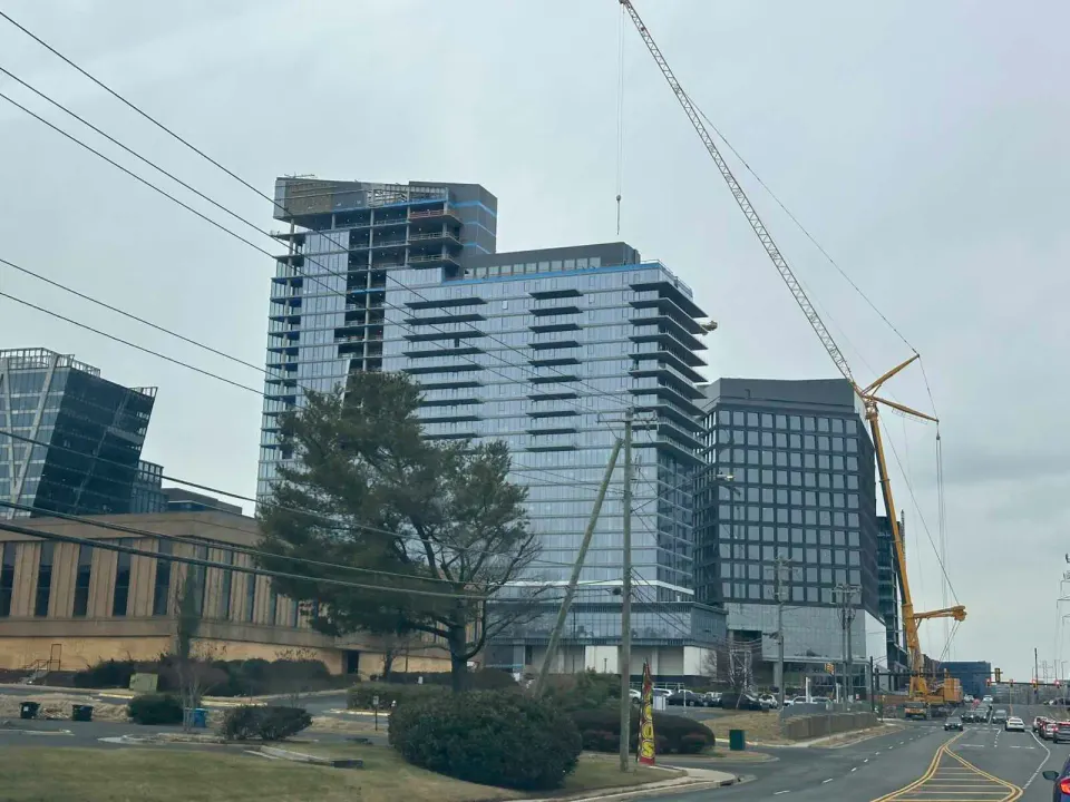 A construction crane next to the Reston Row buildings along Sunset Hills Road (staff photo by Angela Woolsey)