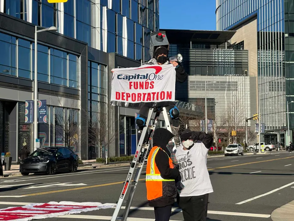 Protesters protesting Capital One on roadway in Tysons, Jan. 13, 2026 (staff photo by Angela Woolsey)