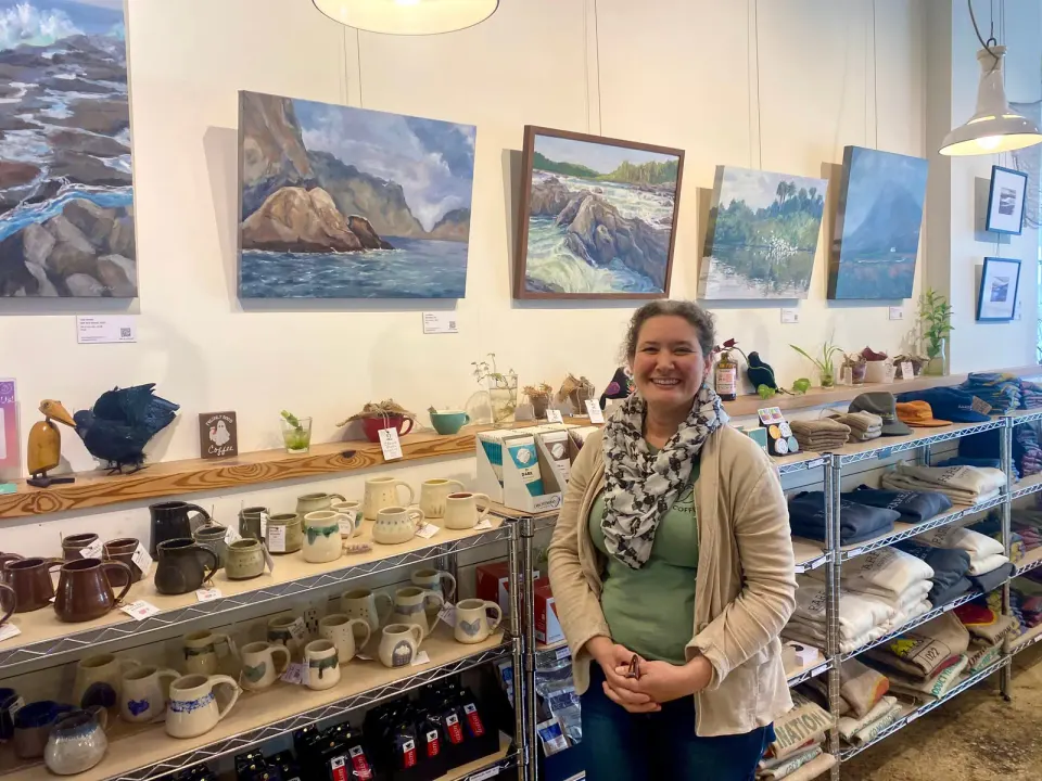 Co-Founder and Owner of Rare Bird Coffee Roasters Lara Berenji stands before the local artworks on display in the café. Photo by Chris Jones.